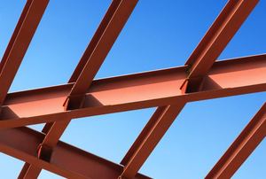 Metal beams against a blue sky.