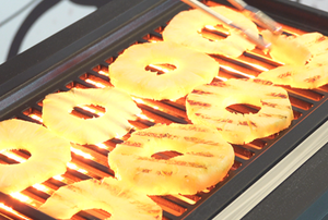 Pineapple slices on a grill
