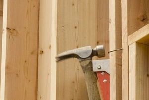 hammering a nail into a stud
