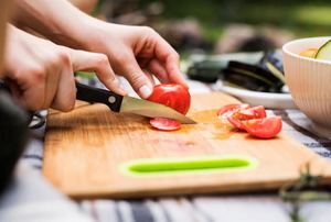 A knife cutting tomatoes.