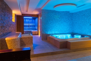 indoor spa and hot tub with colorful lighting