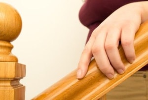 a woman holding a wooden star railing