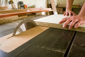 carpenter cutting a wood panel