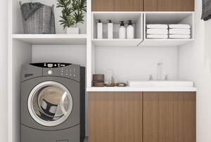 A laundry space with appliance, shelves, and cabinets.