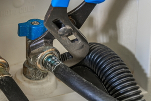 wrench adjusting washing machine shutoff valve