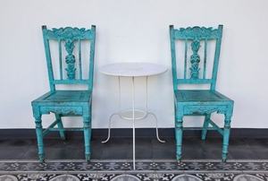 A set of blue shabby chic chairs.
