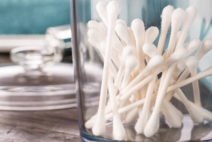 Cotton swabs in a jar on a countertop.
