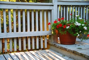 porch with white wooden railings and flowers