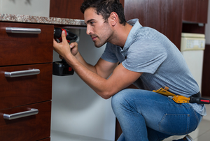 Man installing a base cabinet with drawers.
