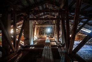 Looking down the length of a long, dark attic.