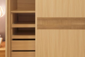 sliding wood closet doors revealing shelves in a room with a hanging lamp