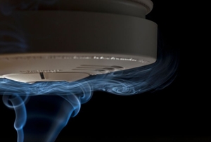 Smoke crawling over smoke detector.