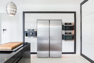 Modern kitchen space with stainless steel refrigerator