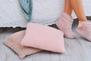 knitted pillows and slippers on feet