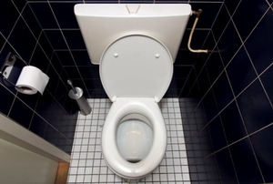 open toilet in a small stall