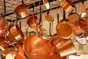 ceiling mounted pot and pan rack with brass cookware