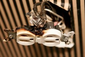 a broken electrical outlet with burn damage