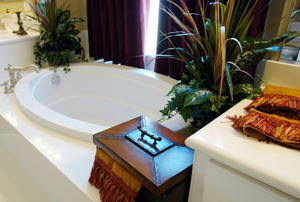 A luxury bathroom with tropical plants.