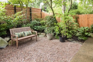 Outdoor sitting area with plants and privacy fence