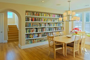 A dining room with built-in bookshelves.