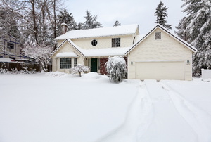 A home with a garage in the winter.