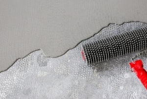 concrete repair layer with a spiked roller
