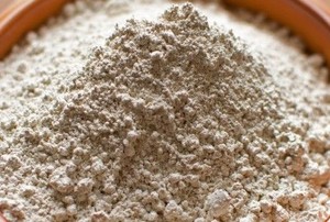 a brown bowl filled with white powder