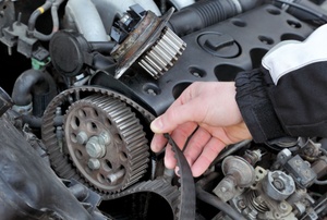 A man holds a lathe belt.