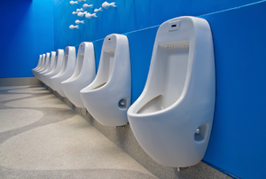 Men's bathroom with a row of urinals