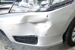 creased dent in front of car