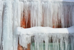 heavy ice hanging off of a house