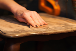 A woman works on a table.