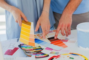 Two people looking over paint color samples