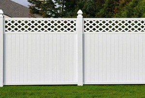 a tall, white privacy fence