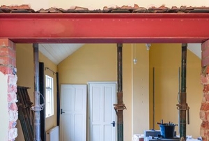 steel beam in masonry pockets above door under construction