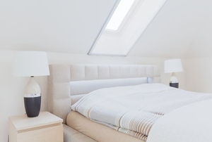 a skylight in a white bedroom
