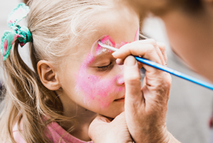 Girl having her face painted