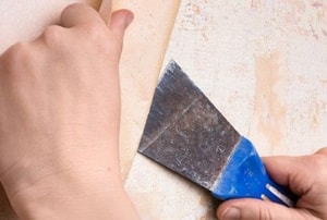 hands removing wallpaper