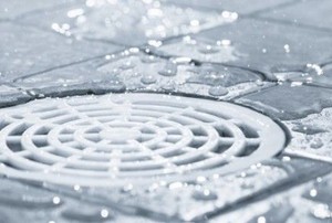 clean tile in a shower around a wet drain