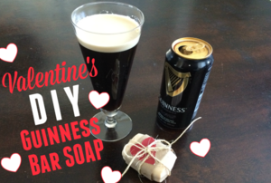 A can and glass of Guinness bear next to a bar of soap decorated for Valentine's Day.