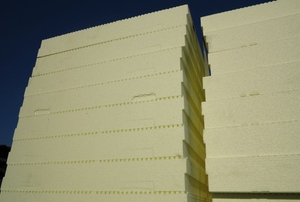 A large stack of thick pieces of foam board insulation.