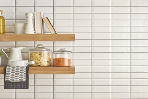 Open shelving in a kitchen with various cooking items on them.