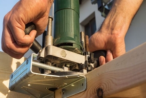 A woodworker using a router.