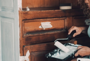 woman painting cabinets