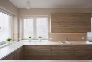 bright windows surrounded by brown cabinets