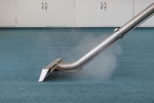 A carpet is steam cleaned.