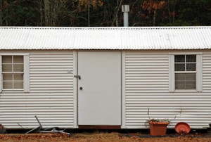 a metal shed with two windows and one door