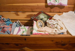 A cedar chest filled to the brim with old family heirlooms.
