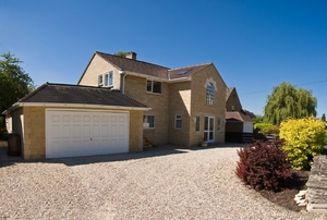 Large house with gravel driveway