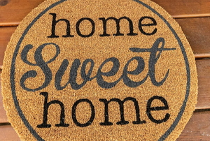 home sweet home welcome mat on wood porch